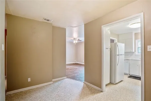 a kitchen with white cabinets and appliances