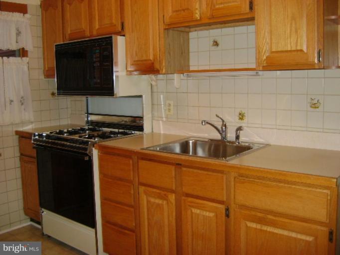 201 Riverthorn Road Middle River, MD 21220 - Photo 4 of 12 a kitchen with stainless steel appliances a stove and a microwave
