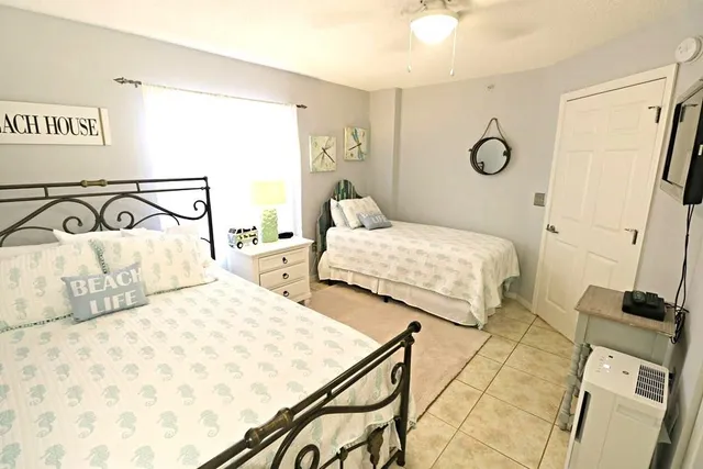 a bedroom with two beds and a dresser