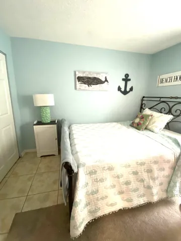 a bedroom with a bed and lamp