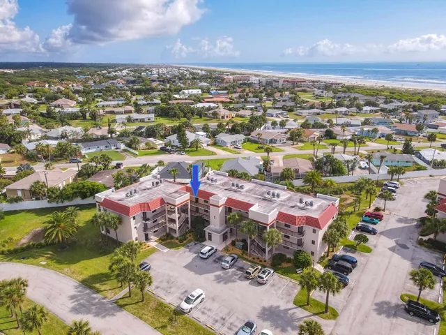 an aerial view of residential houses with outdoor space and swimming pool