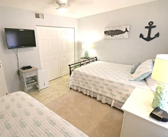 a bedroom with a bed and a flat screen tv