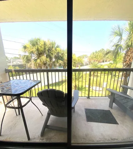a view of a chairs and table in patio