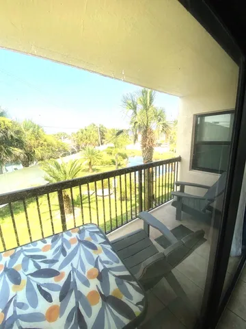 a view of a balcony with wooden floor