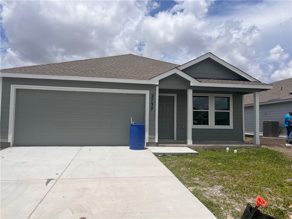 a front view of brick house with a yard