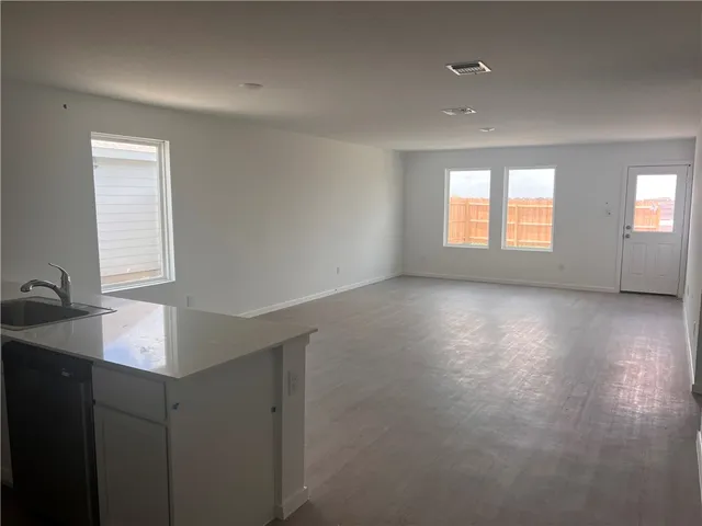 a kitchen with cabinets and window