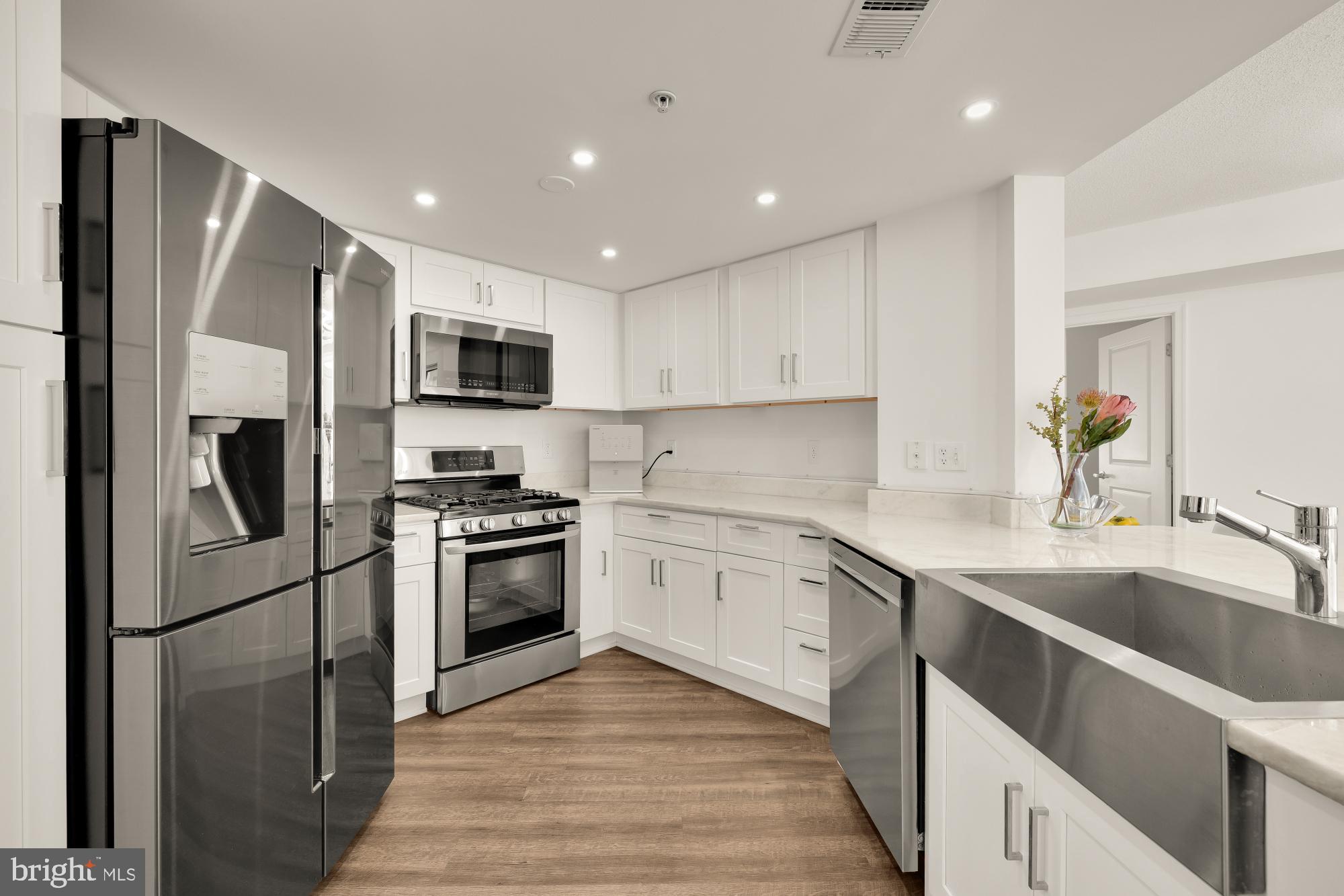 915 E Street Northwest, Unit 815 Washington, DC 20004 - Photo 11 of 26 Modern kitchen with white quartzite.