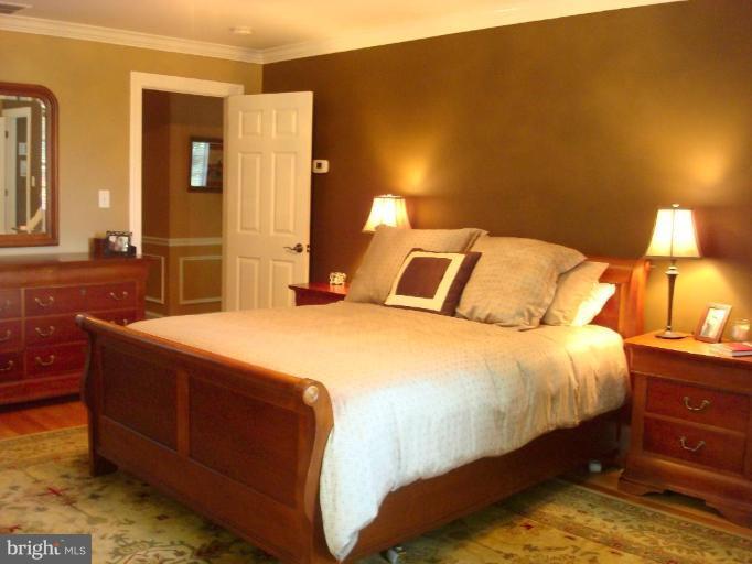 13603 Bardon Road Phoenix, MD 21131 - Photo 14 of 30 a bedroom with a bed and a lamp