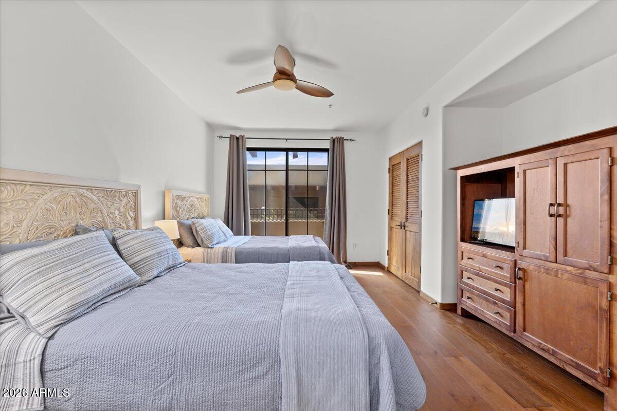 36601 North Mule Train Road, Unit C16 Carefree, AZ 85377 - Photo 25 of 38 a bedroom with a bed flat screen tv and a large window