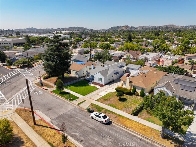 an aerial view of residential houses with city view