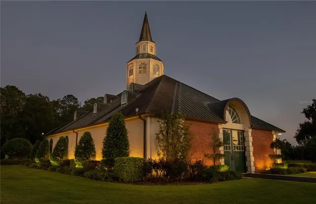 a swimming pool with barbeque oven in front of it