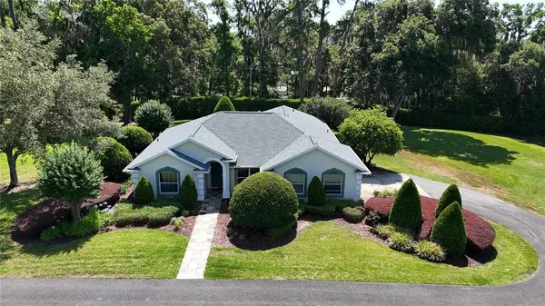 a view of a house with backyard sitting area and garden