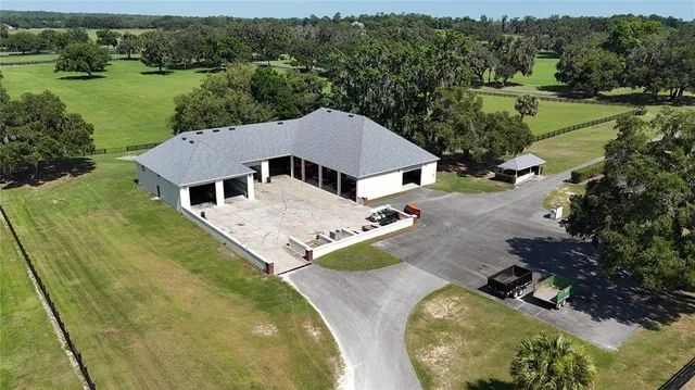 an aerial view of a house with pool patio and lake view
