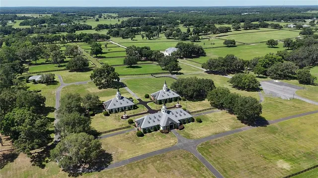 an aerial view of a houses with outdoor space and lake view