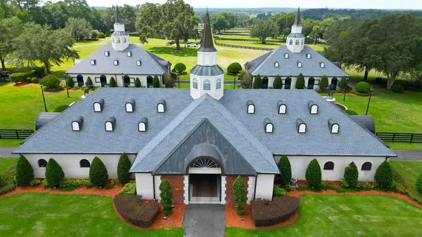 an aerial view of a house with swimming pool garden view and a garden