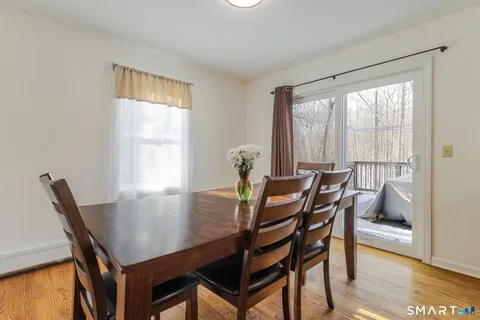 a view of a dining room with furniture and wooden floor
