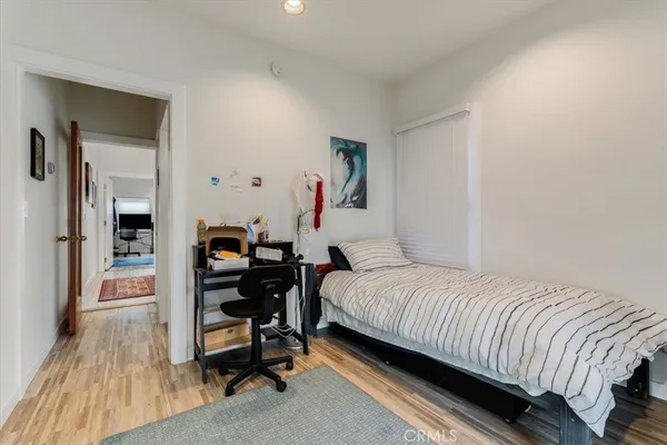 a bedroom with a bed and a desk