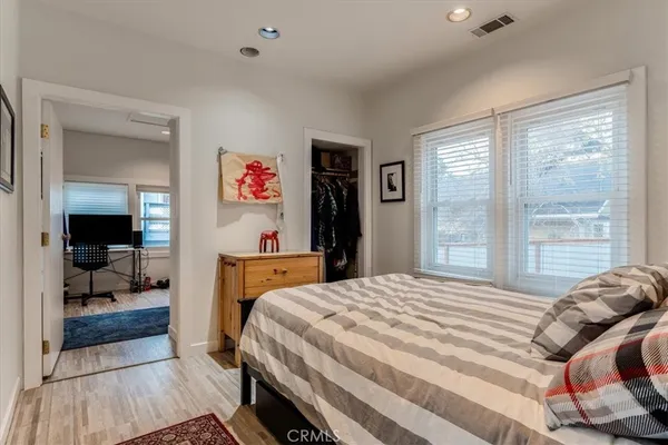 a bedroom with a bed and wooden floor
