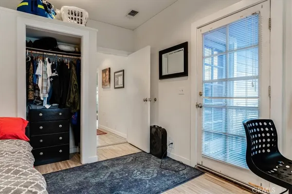 a view of walk in closet and bedroom