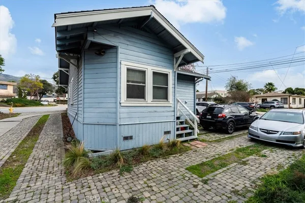 a couple of cars parked in front of a house