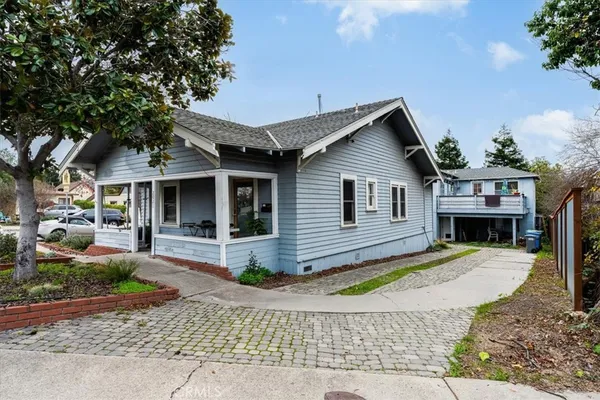 a front view of a house with a yard outdoor seating and garage