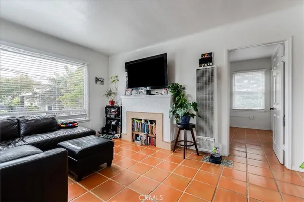 a living room with furniture a flat screen tv and a fireplace