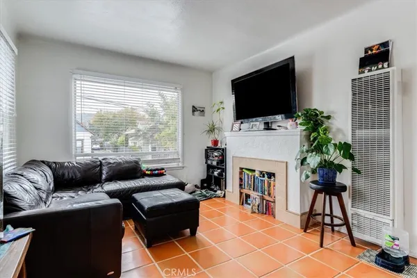 a living room with furniture a flat screen tv and a fireplace