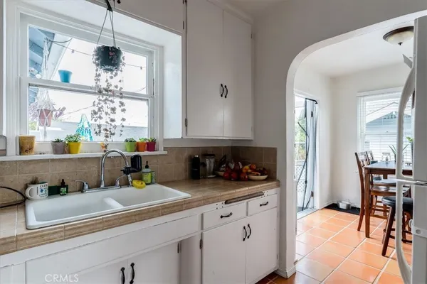 a kitchen with a sink cabinets and window