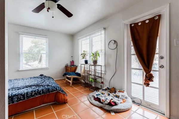 a bedroom with bed and a chandelier