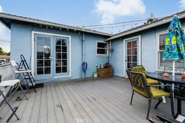 a view of a deck with table and chairs with wooden floor and fence