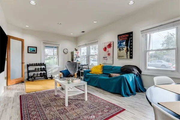 a living room with furniture rug and window