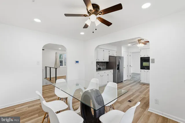 a living room with furniture kitchen view and a chandelier