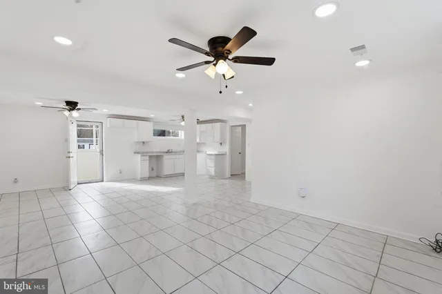 a view of a livingroom with a ceiling fan and window