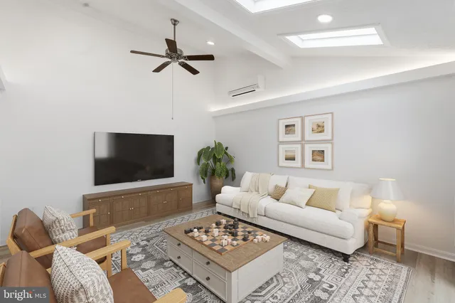 a living room with furniture a rug and a flat screen tv