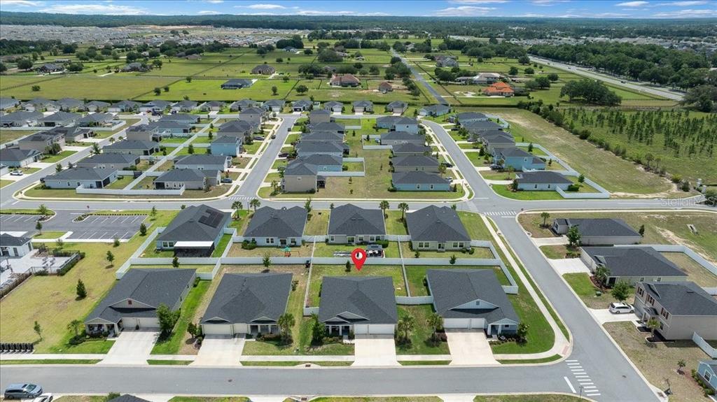9329 Southwest 57th Terrace Ocala, FL 34476 - Photo 60 of 64 an aerial view of residential houses with outdoor space and parking