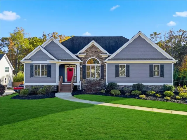 a front view of a house with a yard