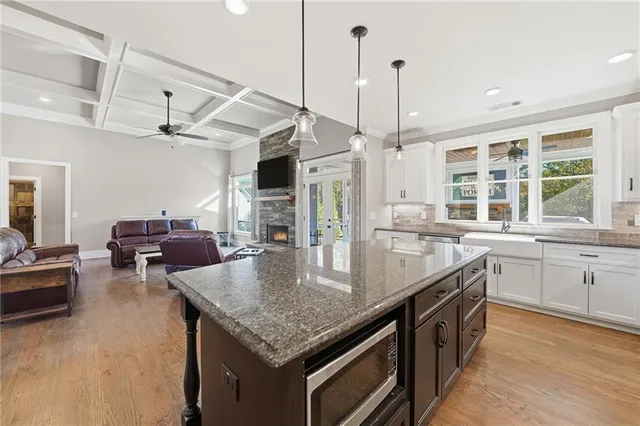 a kitchen with furniture a counter top space appliances and a center island