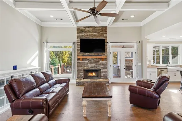 a living room with furniture a fireplace and a flat screen tv