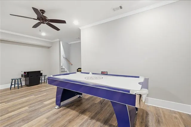 a room with a table chairs and wooden floor