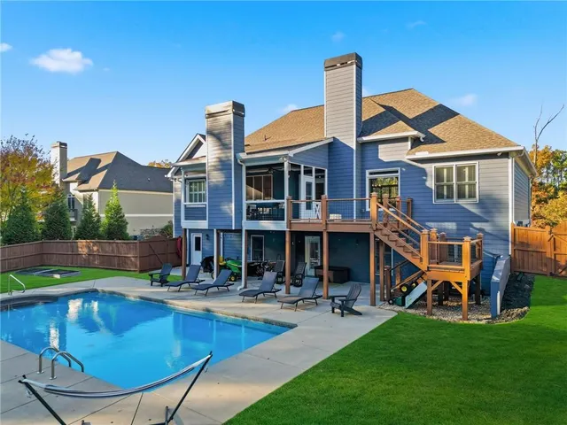 a house view with swimming pool and garden space