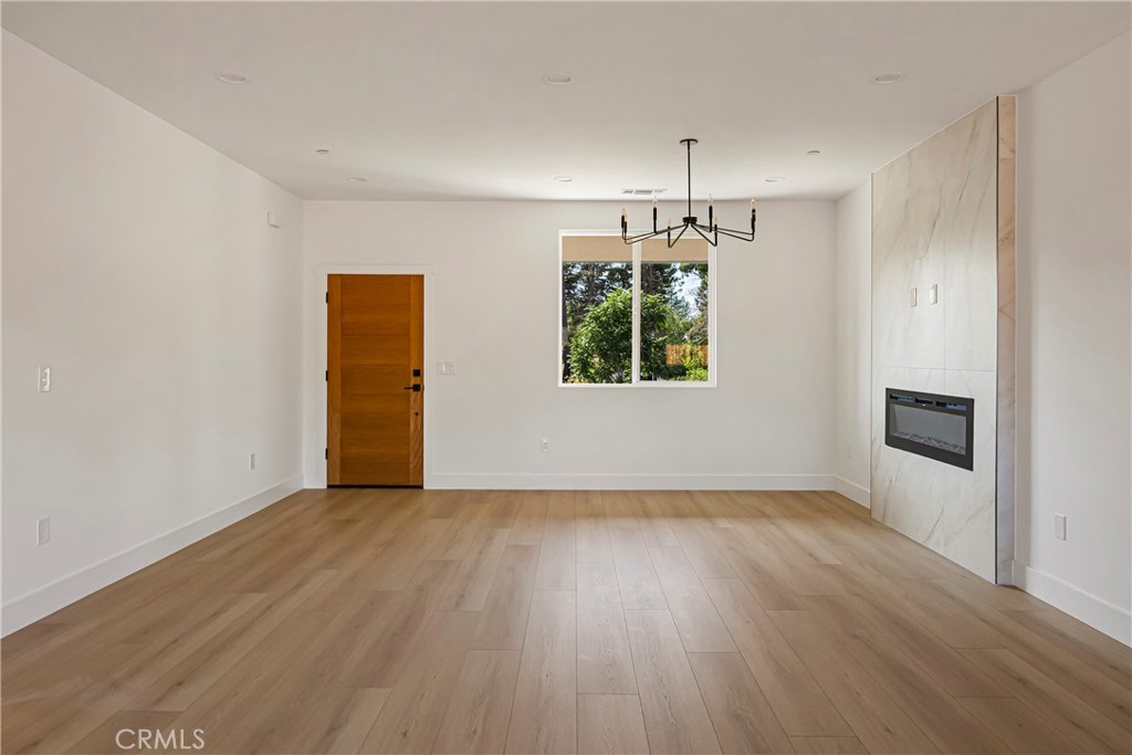 7278 Pentz Road Paradise, CA 95969 - Photo 11 of 36 an empty room with wooden floor chandelier and windows