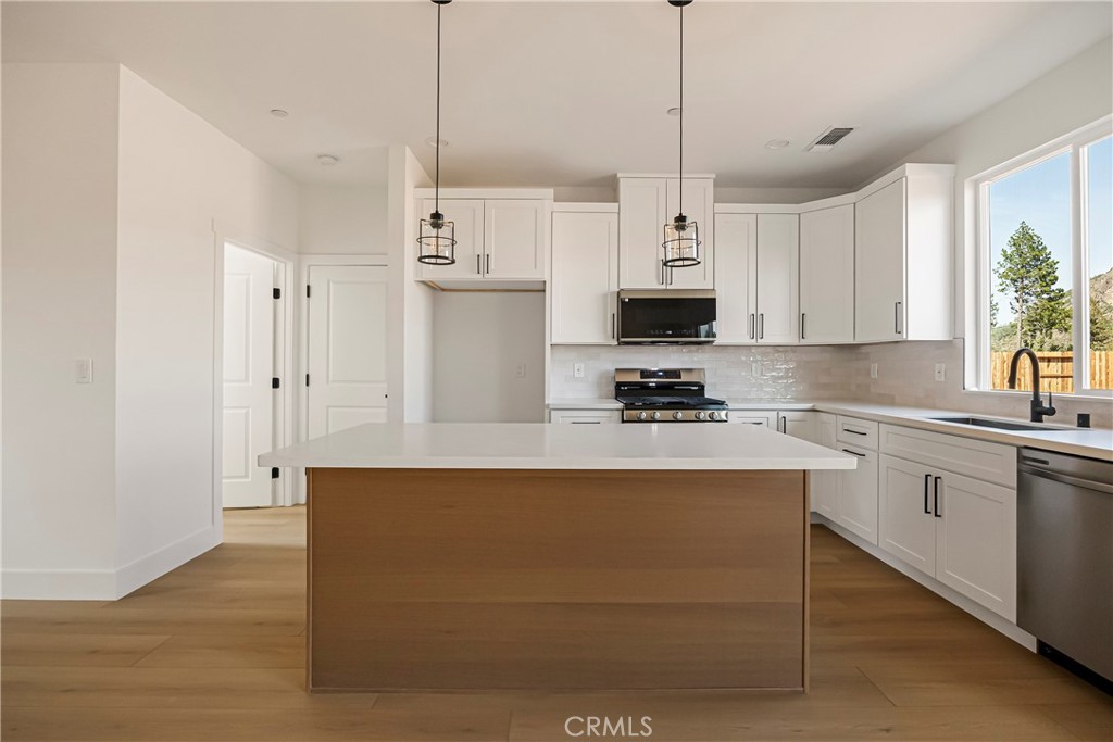 7278 Pentz Road Paradise, CA 95969 - Photo 13 of 36 a kitchen with stainless steel appliances granite countertop a refrigerator a stove a sink and a microwave