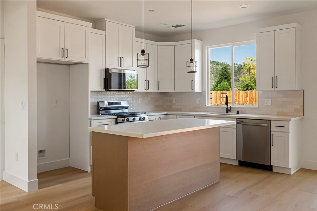 7278 Pentz Road Paradise, CA 95969 - Photo 14 of 36 a kitchen with stainless steel appliances granite countertop a sink a stove a refrigerator and a refrigerator