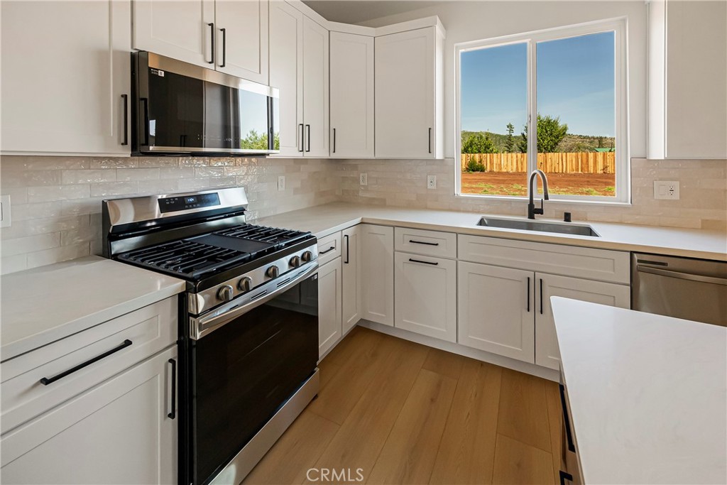 7278 Pentz Road Paradise, CA 95969 - Photo 15 of 36 a kitchen with cabinets stainless steel appliances and a sink