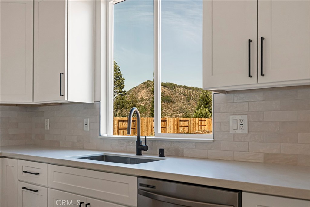 7278 Pentz Road Paradise, CA 95969 - Photo 16 of 36 a kitchen with granite countertop white cabinets and a window