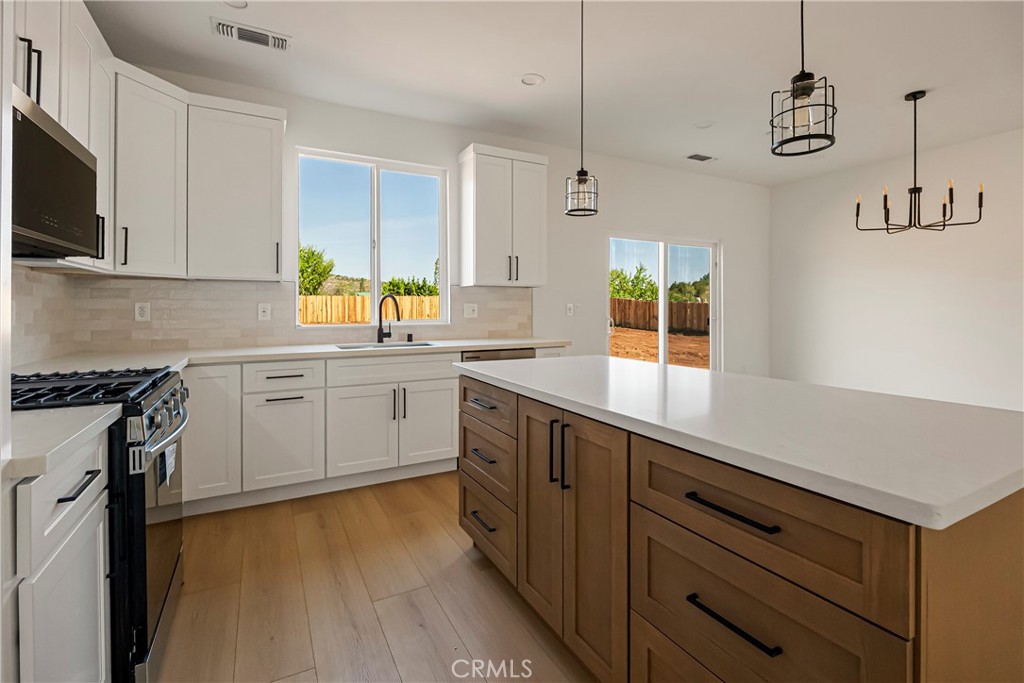 7278 Pentz Road Paradise, CA 95969 - Photo 3 of 36 a kitchen with a sink window and cabinets