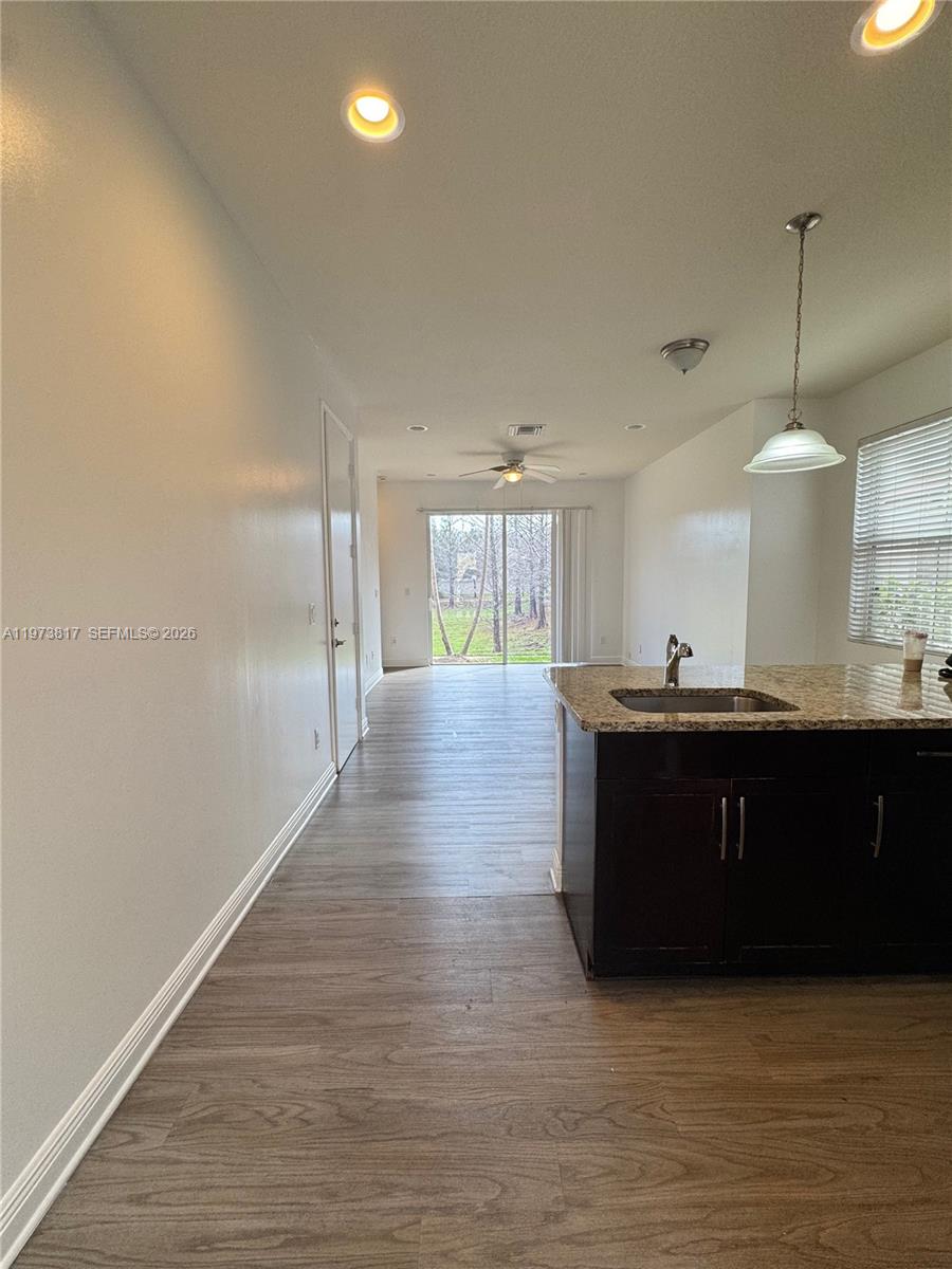 7658 Northwest 88th Terrace, Unit 12 Tamarac, FL 33321 - Photo 2 of 12 a kitchen with stainless steel appliances granite countertop a refrigerator and a sink