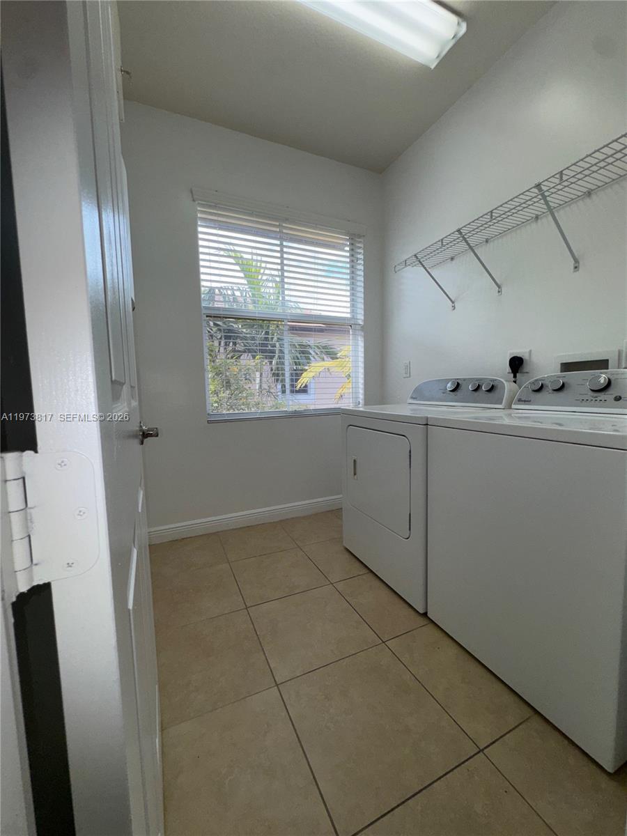 7658 Northwest 88th Terrace, Unit 12 Tamarac, FL 33321 - Photo 7 of 12 a view of an empty room with windows