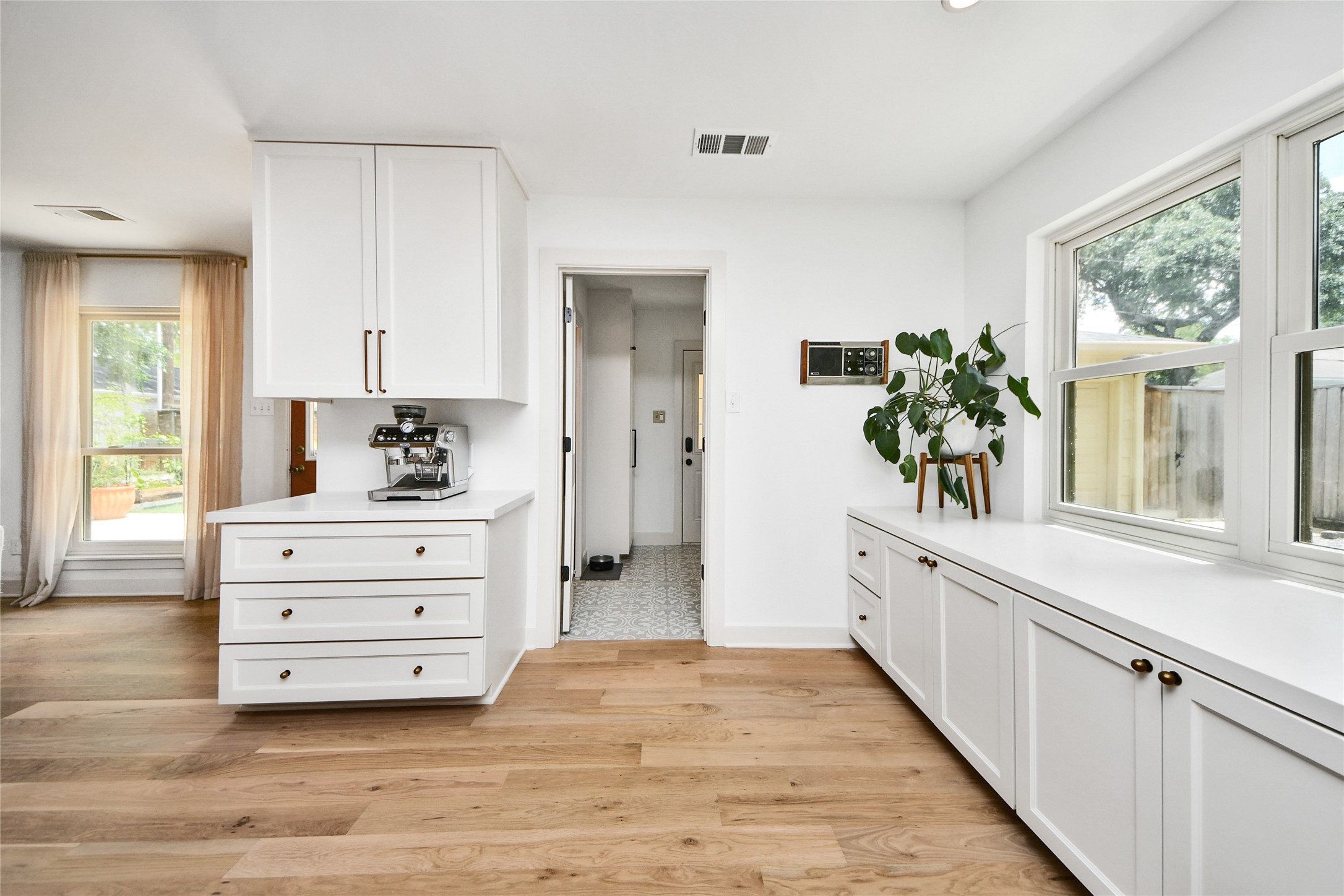 3030 Bernadette Lane Houston, TX 77043 - Photo 10 of 31 a kitchen with white cabinets and window