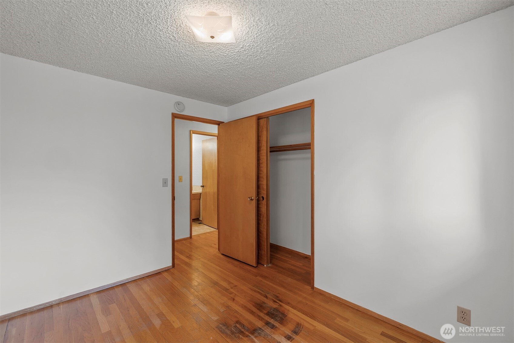 1027 South 112th Street Seattle, WA 98168 - Photo 11 of 33 a view of an empty room with wooden floor